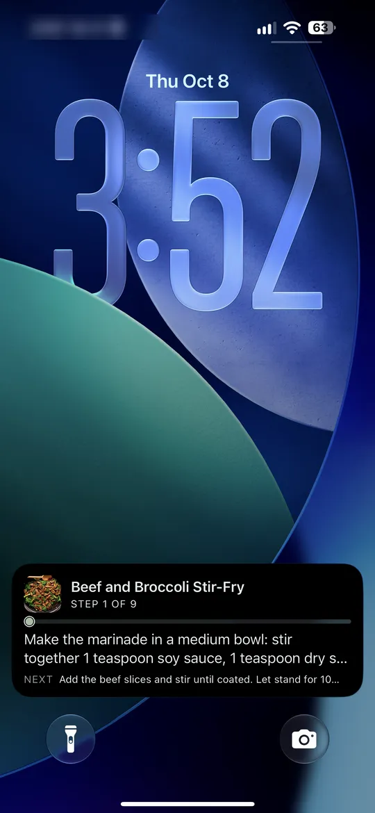 The Lock Screen while cooking. Marker 1 points at the Dinnertime Live Activity showing the dish, the step you are on and the next step.